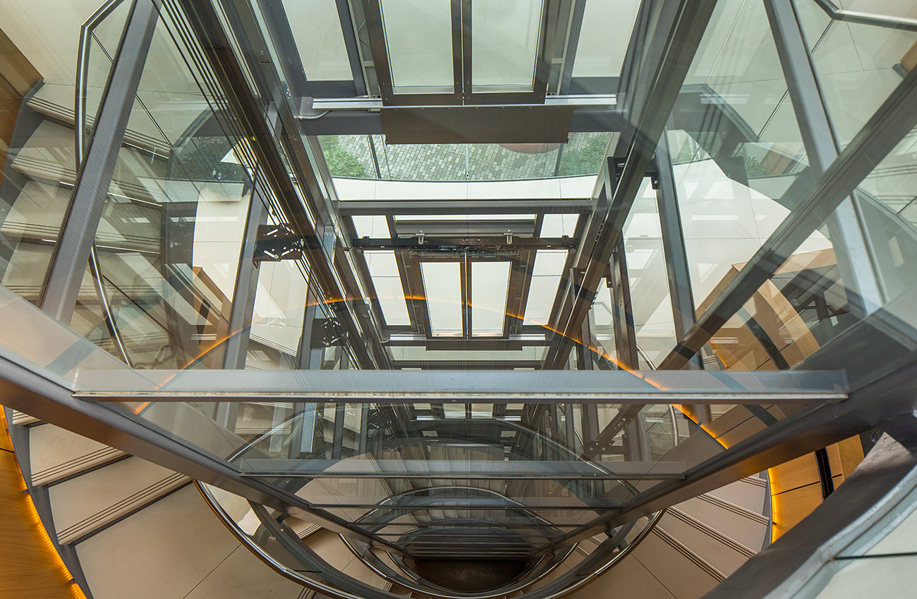 Lift Installation Oxford, dickson Poon university of oxford china centre building, looking down glass lift shaft