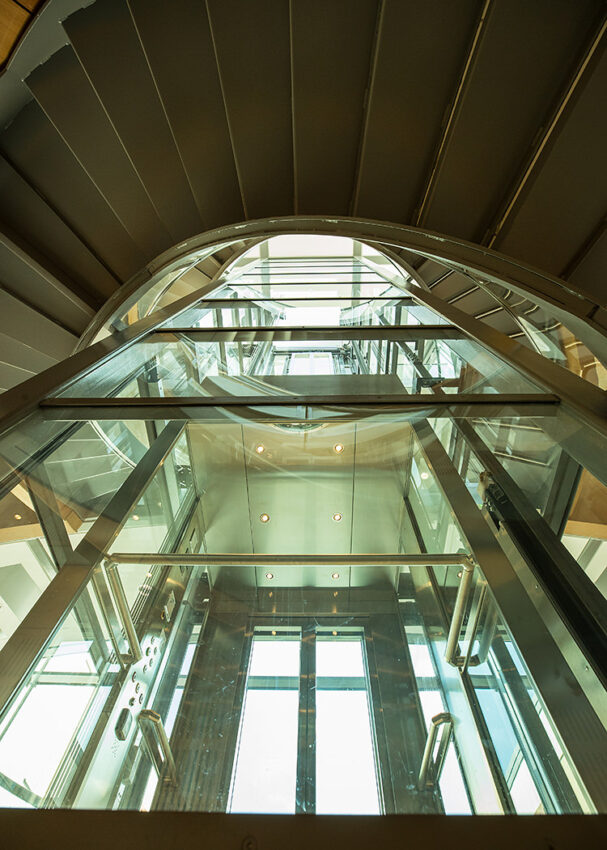 Lift Installation Oxford, dickson Poon university of oxford china centre building, looking up glass lift shaft
