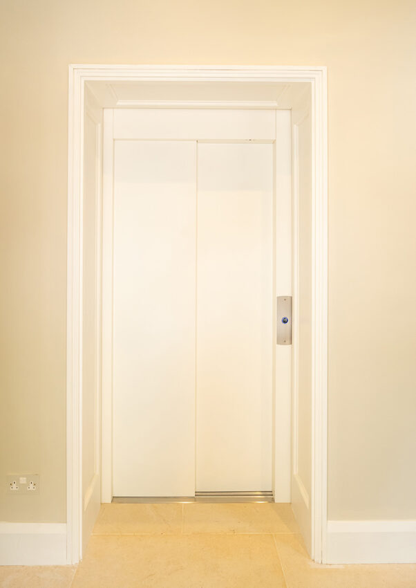 Home Lift Installation in a residential private home shoing white bespoke steel lift doors