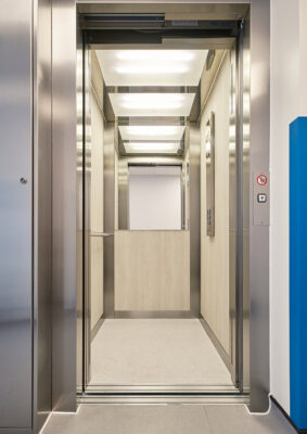 Lift Interior design by Morris Vermaport Lifts showing wood veneer paneling